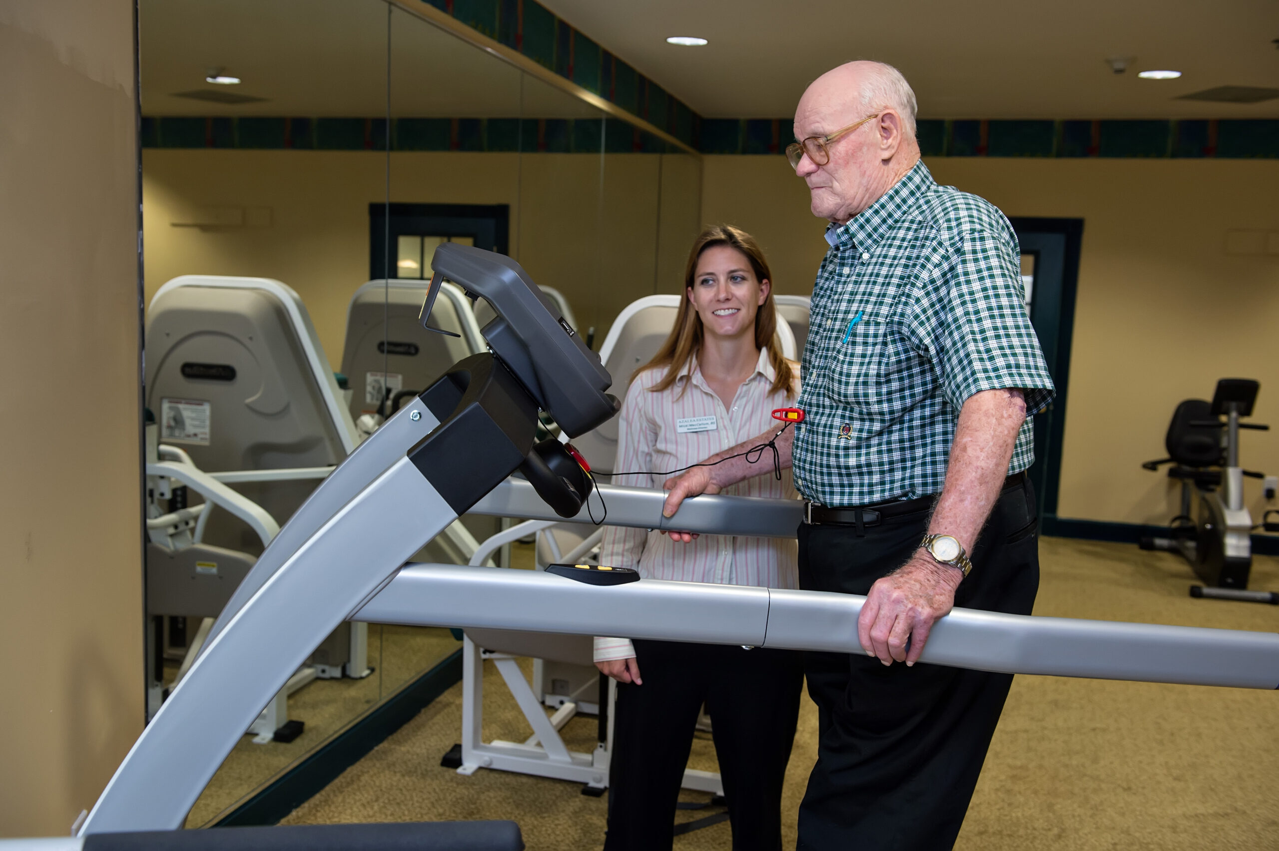 Azalea Estates staff member guiding a resident one-on-one