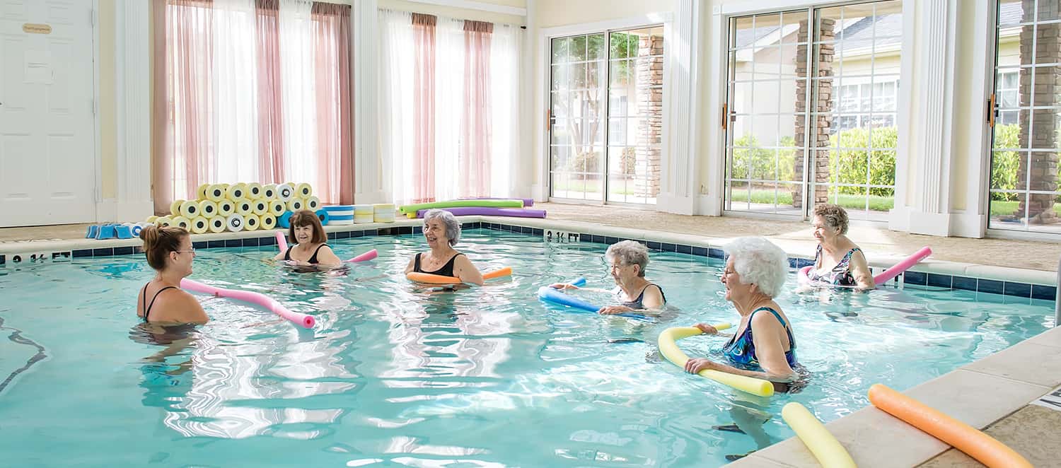 Aqua aerobics — six residents and trainer in our indoor pool