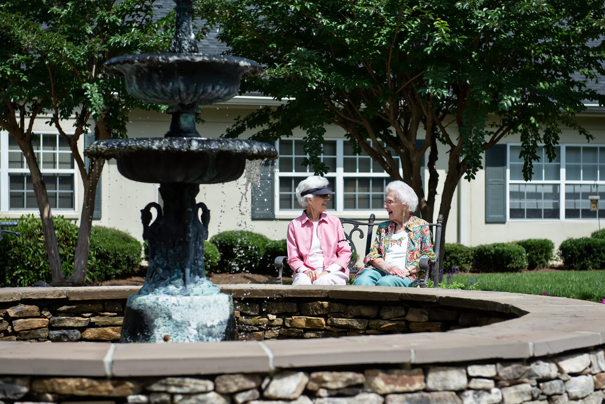 Campus fountain surrounded by landscaped grounds